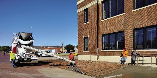 Construction crews repaired the sidewalk on the south side of the Olney Sub Courthouse last week to make way for a new access ramp and a child custody drop-off area with cameras. Photo by Gina Keating