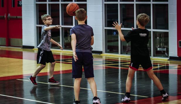 One camp one activity had Cubs in groups of three passing the ball as they dribbled from one end of the court to the other. Photo by Will Sadler