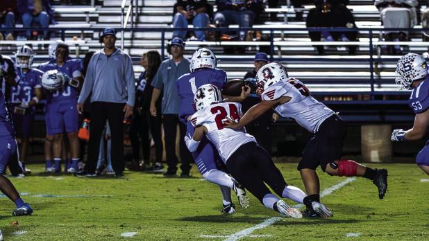 Cub defender #24 Pedro Carrion scrambled through Bulldog defenders making a tackle for loss on the Bulldog runner. Photo by Will Sadler