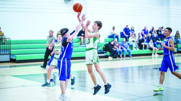 NJH Bobcat #10 Liam Banner shoots a floater over a Longhorn defender. Photo by Will Sadler