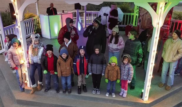 Pastor Chad Edgington of First Baptist Church of Olney led children and community members in carols again this year, a favorite of attendees each year. Photo by Will Sadler