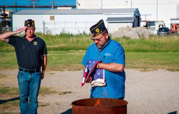 Olney Post 414 Chaplain Steven Nurre retires flags to the flames during the Sunday flag retirement ceremony. Photo by Will Sadler