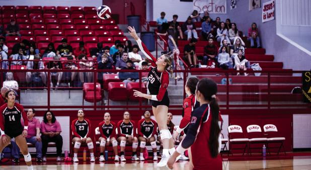 Lady Cub #20-Natalie Simmons sends a fiery shot over the net towards Lady Trojan defenders. Photo by Will Sadler