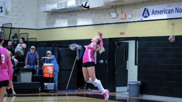 OHS Lady Cub #4 Taylor Cadotte slams a serve to waiting Ladycat defenders.