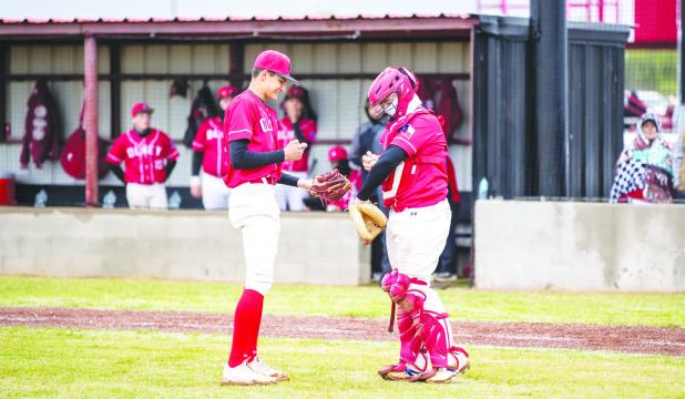 OHS Cub catcher #4 Case Gray dry’s off the ball for pitcher #11 Tucker Cortinez and maybe a joke to ease tensions at the mound. Photo by Will Sadler