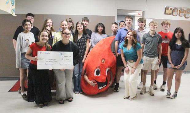 A representative of Carter BloodCare came to Olney High School Wednesday, Sept. 23, to present the National Honor Society with a $500 check. Pictured with the donation are (front, L-R) Braelyn Casteel, Jordynn Petty, Maddox Johnson (as Buddy the Blood Dro