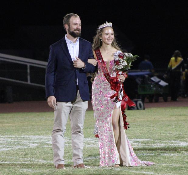 OHS senior Ava Stewart stands with her father, Will Stewart, at the 50-yard line in Cub Stadium after Ava was named 2026 Homecoming Queen on Sept. 18. Photo by Gina Keating