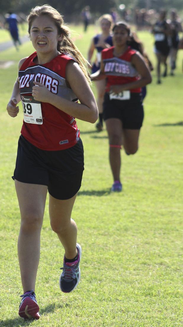 Olney High School cross country runner Leslie Acuna kicks as she nears the Seymour District Meet finish line.