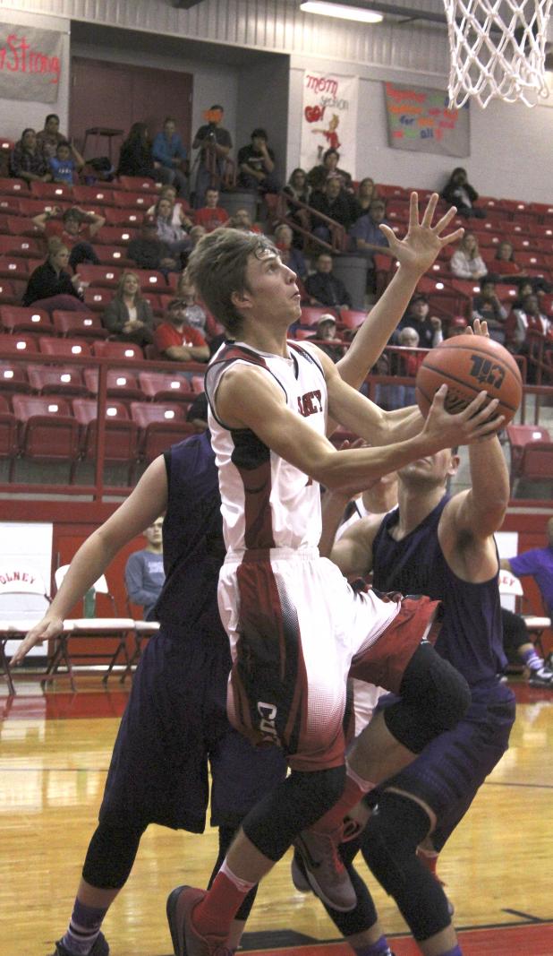 Olney High School senior guard Carson Fite puts in a layup during the first half of a game against Jacksboro.
