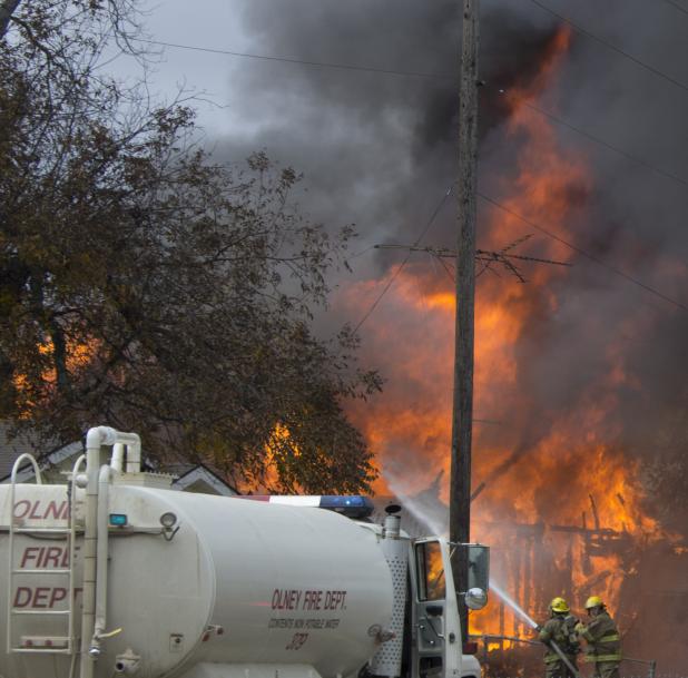 Olney Volunteer Fire Department firefighters battle a blaze on the 500 block of Bloodworth Tuesday morning. Angela Stephens/Enterprise