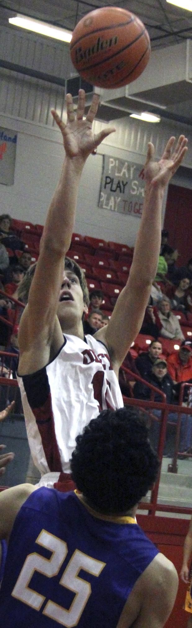 Olney High School sophomore forward Parker Mayers goes up for a jumper against Munday.