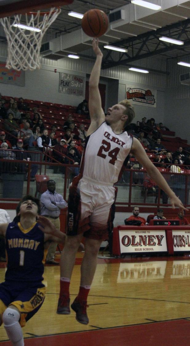 Olney High School senior guard Andrew Benhardt goes for a layup against Munday.