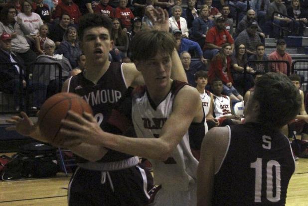 Olney High School senior guard Brent McCorkle fights of Seymour's aggressive defenders.