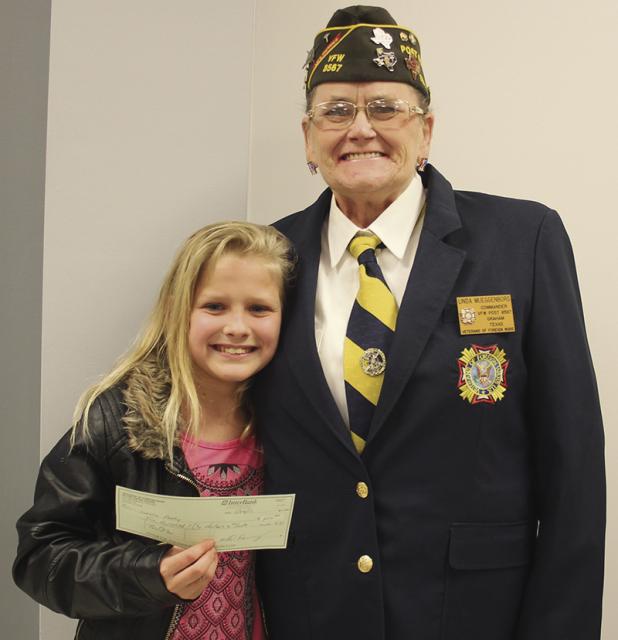 On left is Olney Junior High School seventh-grade student Lorelei Perry-Church posing for a photo with her $250, VFW Post 8567 Patriot Pen Contest first-place check, alongside VFW Post 8567 Commander Linda Muggenborg.