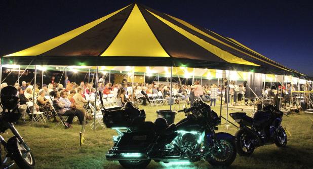 Hundreds gather Sunday for the first night of the Community-Wide Tent Revival, just off Main Street in Olney.