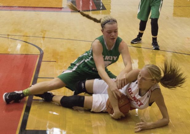 Above: Newcastle sophomore guard Arryn Eli and Olney senior guard Niki Wade fight for possession during Tuesday’s season opener. Newcastle won 55-37.