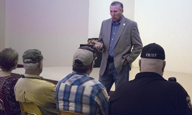 House District 68 State Rep. Drew Springer visits with a group of Olney citizens inside the Olney Civic Center while touring the area Monday afternoon.