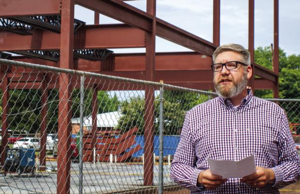 First Baptist Church of Olney Pastor Chad Edgington delivers remarks to attendees at the topping out ceremony for the church’s new $7 million education building. Photo by Gina Keating