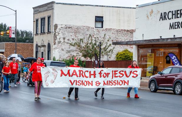 The 28th March for Jesus went off as planned on Oct. 4, despite a steady drizzle. Marchers headed down Main Street to the First Baptist Church of Olney for worship, luncheon, and prize giveaways. Photo by Will Sadler