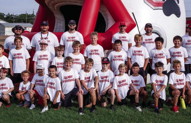 Attendees of the Kindergarten through 5th grade Cub football camp pose for a team photo. The camp for the younger athletes previews two-a-day workouts for Olney High School athletes, whose season begins in earnest in August. Photo by Will Sadler