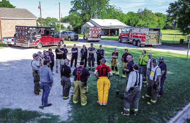 Firefighter Dustin Hudson led smoke training for the Olney Volunteer Fire Department that included multiple City of Olney departments. Here, Hudson gives safety instructions and the agenda for the day’s activities on May 30. Photo by Will Sadler