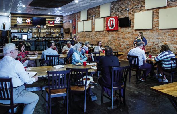 Members of the Olney Chamber of Commerce gathered at Hudson’s on Main on Monday, July 27 for a lunchtime seminar on using Aritifical Intelligence in business. Photo by Will Sadler