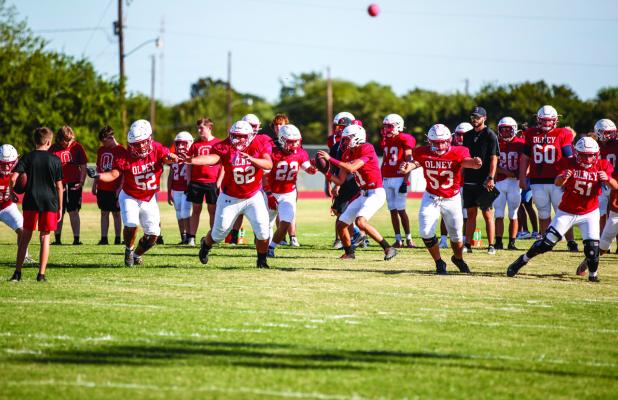 The Cubs Offensive line is confident this season, with a seasoned running back in Kyle Stewart. Cubs warming up before their scrimmage with the Eagles. Photo by Will Sadler