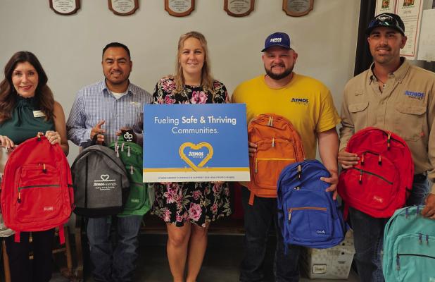 Atmos Energy employees deliver backpacks to Olney Elementary School: (L-R): Pam Hughes Pak and Carlos Trevino, Assistant Principal Kalynn Philipp, Atmos Energy’s Riley Whitson and Trevor Whitsitt. Photo provided by Atmos Energy
