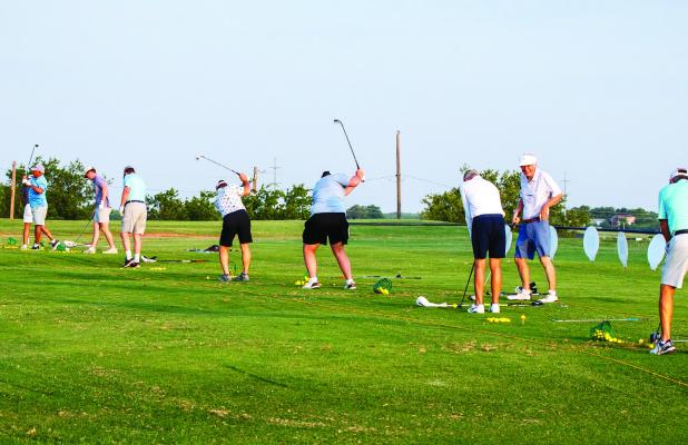 Golfers attending the Olney Country Club’s McClatchy Tourney warm up before tee off on the driving range and putting green. Photo by Will Sadler