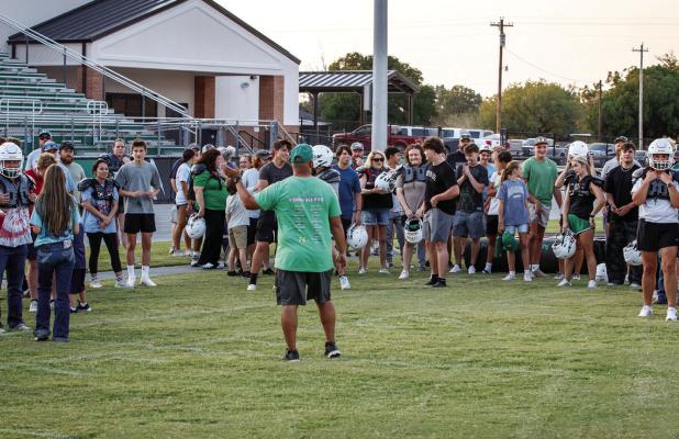 Newcastle ISD Athletic Director and Head Bobcat Football Coach Asiah Archer goes over the importance of the annual tradition of Tackle with Moms. Coach Archer said in part that the event helps show what players go through during practice. Photo By Will Sa