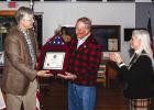 Dale Lovett receives a plaque containing a U.S. flag that flew over the U.S. Capitol in Washington D.C. from Young County Judge Win Graham and Melanie Berry, the area representaitve froom the office of U.S. Rep. Roger Williams, who procured the honor for 