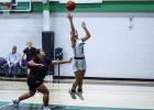 Ladycat #11 Emma Hawkins shoots one from under the bucket after brushing by Lady Greyhound defenders. Photo by Will Sadler