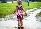 The Olney in America celebration was rained out but that didn’t stop many from making memories in the rain, like Colter Owens who enjoyed good old fashioned puddle splashing. Photo by Jackie Owens