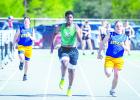 NHS Bobcat Jacob Omundi gave the competition a run during the 100m. Pick up a copy of the Enterprise next issue for results of the NHS Coal Mine Relays. Photo by Will Sadler