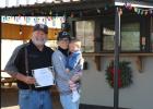 Barry and Ann Hodges and their grand-daughter Emilia Jane show off an Olney Chamber of Commerce certificate celebrating their second anniversary in business in Olney. Congratulations, Big Luv! Photo by Gina Keating