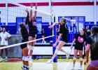 A varsity Ladycat slams a kill shot past a defender. Photo by Will Sadler