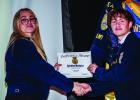 OHS FFA Treasurer Jordynn Petty presents FFA member Vice President Tristan Bishop with Ag Mechanics Proficiency award. Photo by Will Sadler