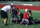 Football is a physical sport, and learning the basics, such as how to safely tackle and block, is important. These players look pretty serious but were all laughs after each player took their turn. Photo by Will Sadler