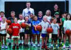 Younger Newcastle children pose with huge grins during Coach Lane Dollar’s summer basketball skills camp. The children appeared to have a great deal of fun. Photo by Will Sadler