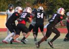 The Cubs offensive line hold off Wildcat defenders as Cubs quarterback Tucker Cortinez, #22 Kyle Stewart, and #3 Dom Collins set a play in motion at the Sept. 18 Homecoming game against Archer City. Photo by Kailyn Altmiller