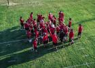 Cub players and coaches finish this year’s first practice with a huddle and a Cub shout before exiting the practice field to hit the weights; a Cubs preparation is never finished. Photo by Will Sadler
