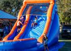 Children enjoyed a fun blow-up slide at the Olney Police Department’s National Night Out. Photo by Will Sadler