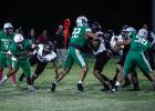 Bobcat linemen #22 Jayden Hemby and #56 Cooper Clayton bulldoze Indian defenders making way for runner #18 Keyton Newland. The Bobcat line had their way with the Indian defenders all night opening huge pathways for running drives. Photo by Will Sadler