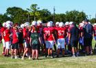 The Cubs have a team huddle after their first possession of the scrimmage with the Eagles to go over strategy for the offensive Cubs entering the field. Photo by Will Sadler