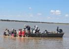 OHS freshmen and sophomore science students assist Texas Parks and Wildlife biologist Wes Dutter in building three additional fish spawning beds at Lake Cooper last month. The group followed junior and senior science students who built three beds for the 