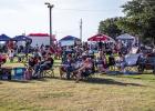The Olney Chamber of Commerce estimated that between 1,200 and 1,300 people attended the Olney In America event at the Olney Country Club on July 2. Here, attendees listen to musicians Foster Sullivan and Daniel Latham, and headliner King George, a George