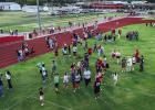 Attendees of the Olney Athletic Booster Club stuck around after the announcement of the fall athletes to socialize over watermelon and cold water. Photo by Will Sadler