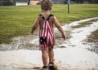 The Olney in America celebration was rained out but that didn’t stop many from making memories in the rain, like Colter Owens who enjoyed good old fashioned puddle splashing. Photo by Jackie Owens