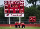 OHS Cubs [L-R] #5 Kanton Rodgers, #11 Tucker Cortinez and #3 Dom Collins take a knee taking a moment in prayer before their game against Petrolia. Photo by Will Sadler