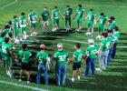 The Newcastle athletes form up into a circle ahead of their Homecoming game against Guthrie to share fellowship, prayer, and words of encouragement.